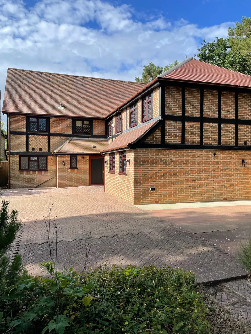 The new two storey extension from the drive, in matching brick with black timber framing