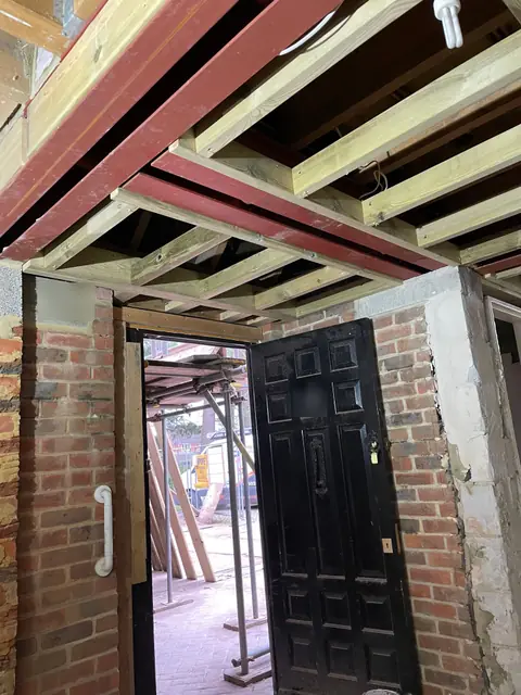 A new doorway with a grab rail, below steel beams and timber joists