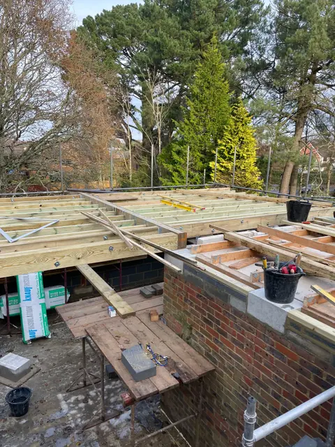 The first floor walls and ceiling joists of the extension, seen from the scaffolding