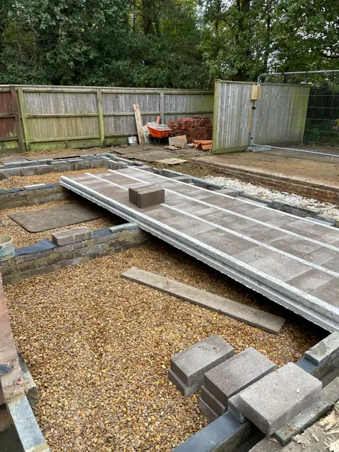Concrete floor beams being laid across the new footings