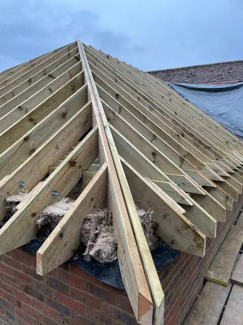 The hip end of the new roof framed in timber