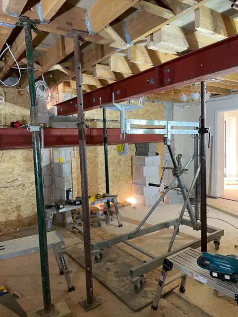 New steel beams inside the house, held on temporary props while walls are taken out
