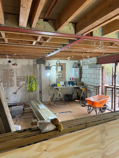 The new open plan space, with steels across the ceiling and the wide opening to the garden