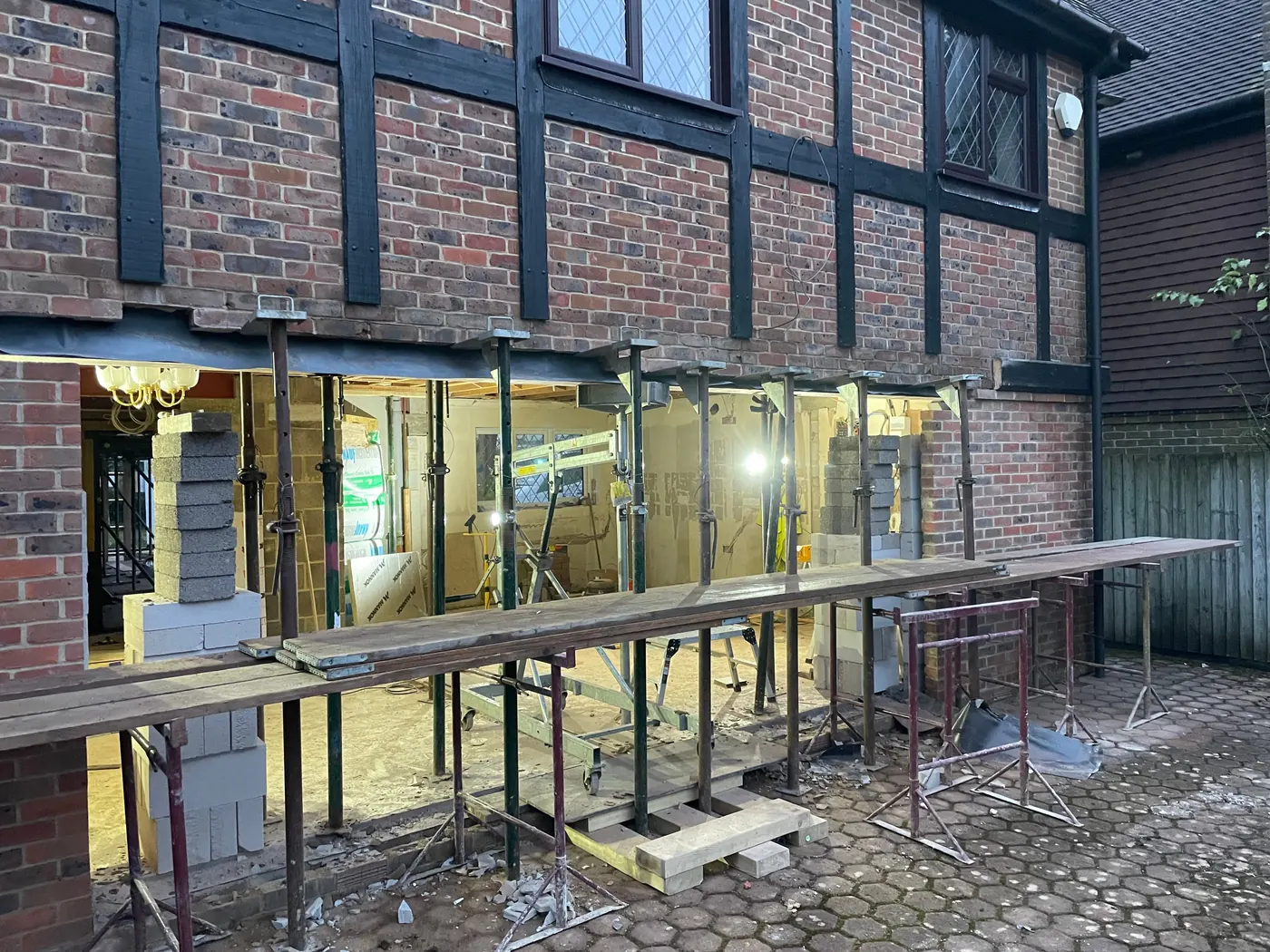 The rear wall held up on props while the ground floor wall below is taken out for a long steel beam