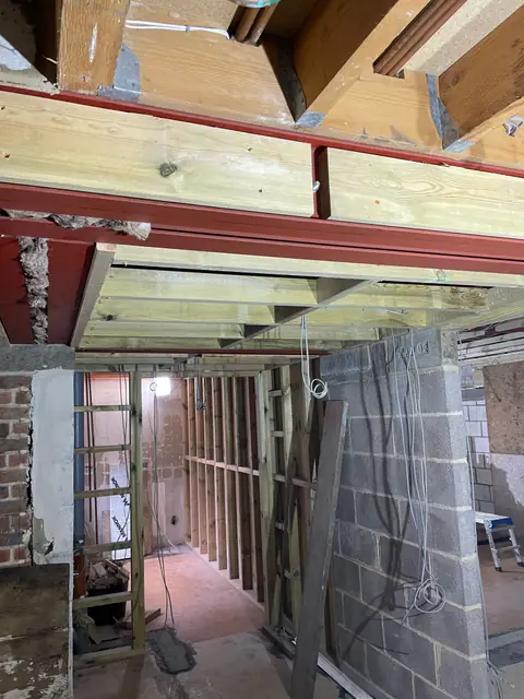 Timber stud walls going up under the steel beams in the extension